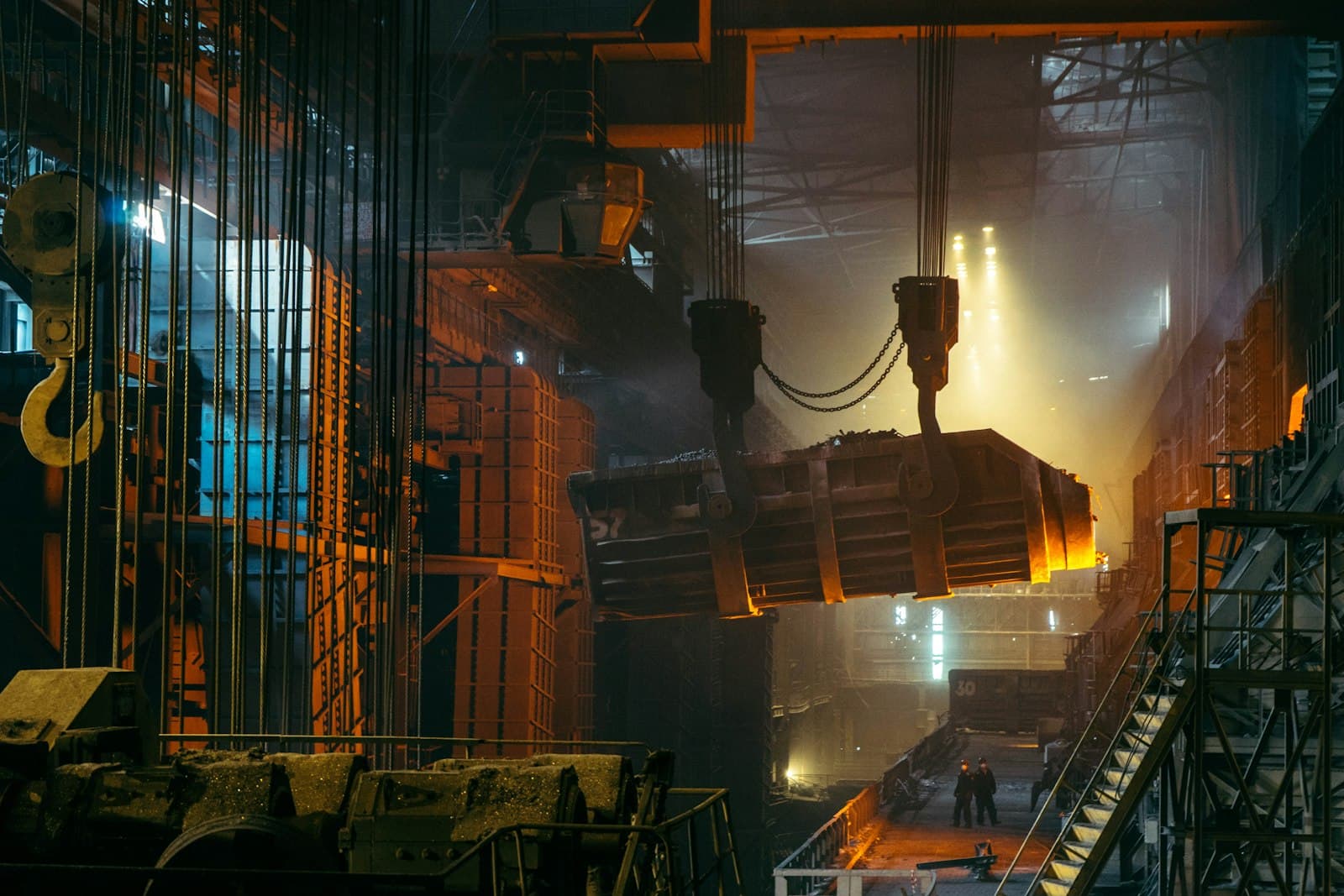 Heavy industrial steel mill with a crane lifting molten metal